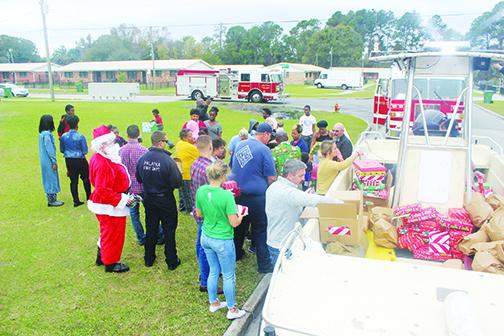 Palatka officials and residents enjoy the fire department's annual gift giveaway.
