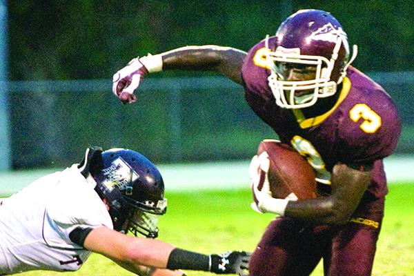 Crescent City Junior-Senior High School's Andre Addison avoids a tackle during the 2009 state playoff game against Jacksonville Trinity Christian. (Daily News file photo)