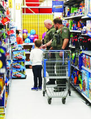 Law enforcement officers take local children on a shopping spree for Christmas.