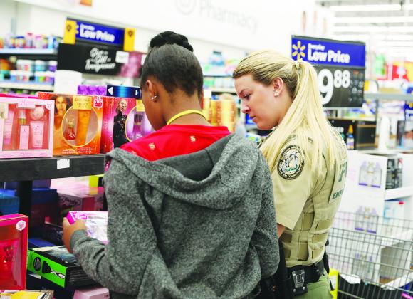 Law enforcement officers take local children on a shopping spree for Christmas.