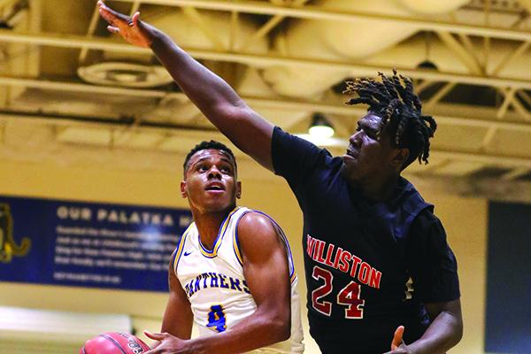 Palatka’s Jimmy Williams, left, goes against Williston’s Kamarious Gates during the first half of Friday's semifinal. (GREG OYSTER / Special To The Daily News)
