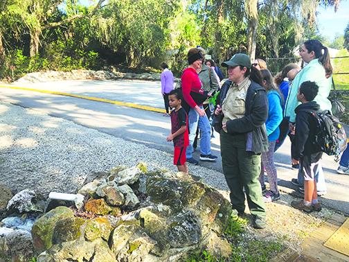 Park Services Specialist Paige Jones guides a group through Ravine Gardens State Park on Wednesday during the park’s annual First Hike Day.