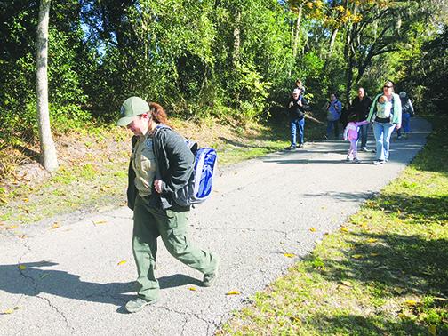 Park Services Specialist Paige Jones guides a group through Ravine Gardens State Park on Wednesday during the park’s annual First Hike Day.