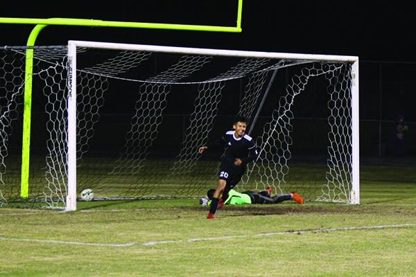 Crescent City's Ivan Camacho runs away from the goal happy after teammate Calletano Santana scored his team's third goal of the game early in the second half. In the background on the ground is Palatka goalkeeper Dalton White. (MARK BLUMENTHAL / Palatka Daily News)