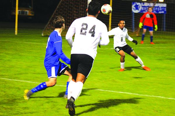 Palatka’s Will Gomez (24) passes the ball to teammate Deven Williams Thursday night as Keystone Heights’ Jordan Holmes can only watch. Keystone Heights won the match, 4-2. (MARK BLUMENTHAL / Palatka Daily News)