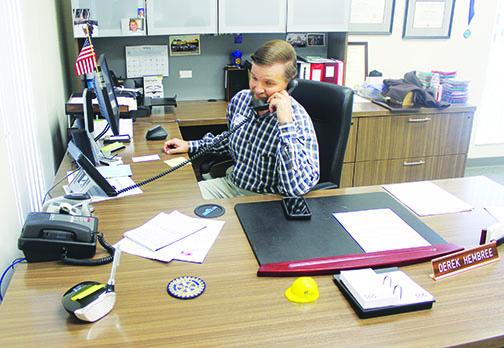 Derek Hembree sits at his desk at the Clay Electric office in Palatka, where he is now the distrcit manager.