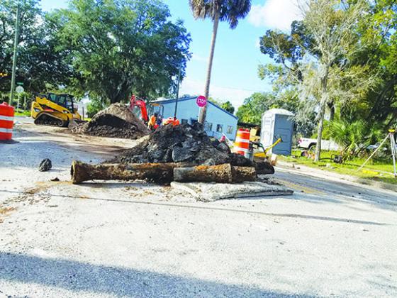 A piece of old, rusted pipe and torn asphalt are piled on Laurel Street in Palatka as Public Works employees perform a drainage construction project earlier this month. More downtown roadwork is planned this year when the city begins repairs and improvements along St. Johns Avenue.