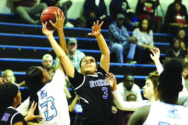 Interlachen’s Alexis Rodriguez (3) shoots against P.K. Yonge’s Nyiasha Grace. (GREG OYSTER / Special To The Daily News)