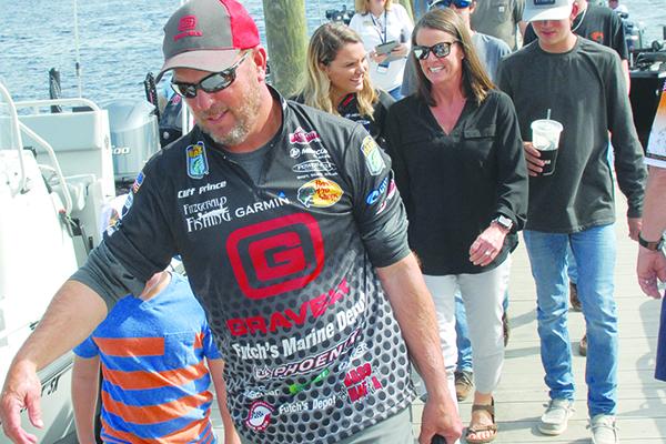 Palatka’s Cliff Prince heads to the scales Monday, followed by wife Kelley (sunglasses), who is flanked by daughter Gracie and son Syler. (GREG WALKER / Special To The Daily News)
