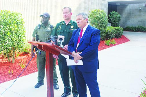 Putnam County Sheriff Gator DeLoach, center, and Superintendent Rick Surrency, right, conduct a press conference Tuesday after a student was arrested and accused of carrying two guns and four knives to Jenkins Middle School.