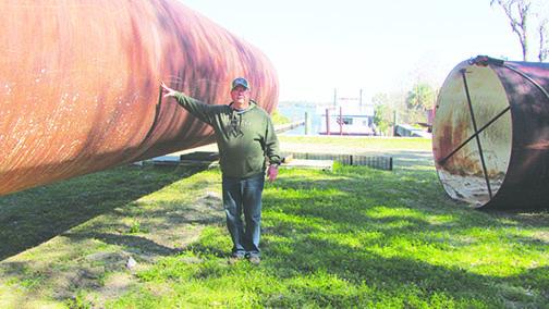 Glenn Martin, project manager for Keuka Energy, stands beside one of the 312-foot-long steel pontoons being used to build a service vessel for the offshore wind platform.