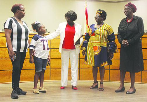 School board Chairwoman Sandra Gilyard celebrates her state certification with her family at Tuesday’s school board meeting.