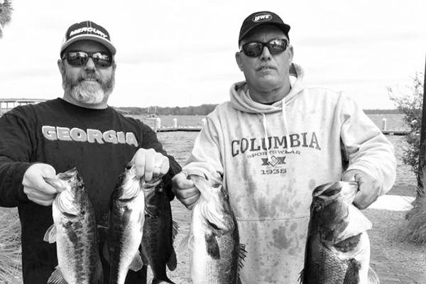 Platt Drew (left) and Rusty Fox hold up their winning fish. (GREG WALKER / Special To The Daily News)