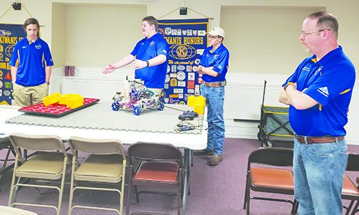 Palatka High School robotics team members Colby Brooks, Micah Hall and Kacen Byrd talk about their robot during a demonstration for the Kiwanis Club of the Azalea City as coach Rob Knutsen looks on.