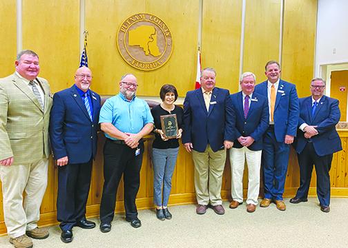 Representatives from the Waterways and Trails Committee were presented with a plaque Tuesday at the Board of County Commissioners meeting to honor Palatka becoming a Trail Town last year.