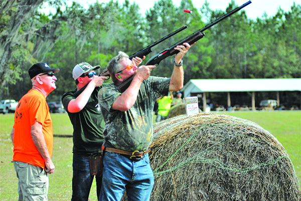 Terry French (front) and Kaleb Hall take aim on pheasant while Tommy Baker (left) looks on. (GREG WALKER / Special To The Daily News)
