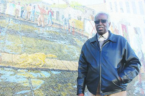 John Alexander, longtime Palatka resident and current president of the Conlee-Snyder Mural Committee, appreciates the detail of a mural in downtown Palatka on Thursday.