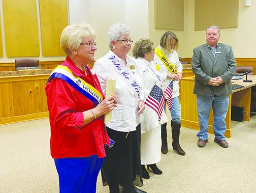 Local Woman’s Club chapter presidents and Board of County Commissioners Chairman Terry Turner celebrate the 100th anniversary of the 19th Amendment on Friday.