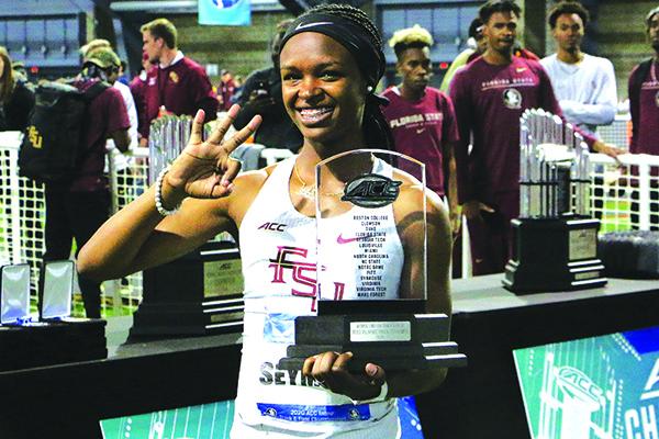 Ka’Tia Seymour flashes three fingers while holding her trophy. (Florida State University Sports Information photo)