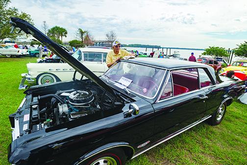 Bernard Laudando of Ocala wipes down his 1964 Pontiac GTO during the car show at last year’s Florida Azalea Festival.