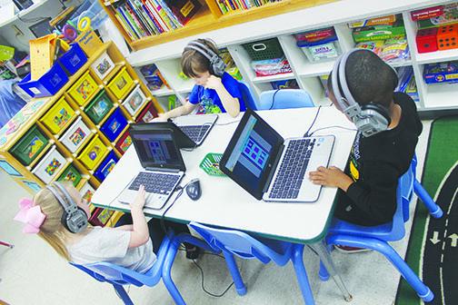 Moseley Elementary School prekindergarten students use computers to learn in class Thursday.