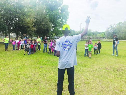 Jenkins Middle School’s Future Farmers of America President Cedric Wright gives a presentation Tuesday to a group of first-graders at the second annual Farm Day.