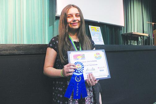 Putnam County Kids Tag Art first-place winner Nadia Ontiveros celebrates her accomplishment Tuesday at the Florida School of the Arts in Palatka.