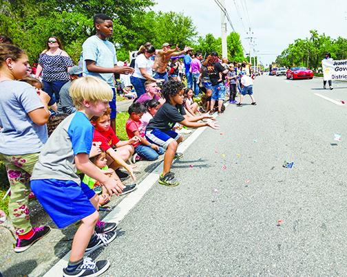 Children catch candy during last year's Catfish Festival.