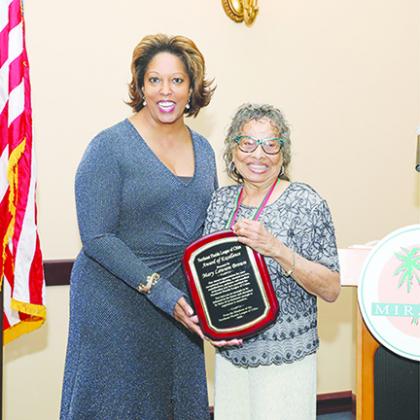 Sarasota City Commissioner Shelli Freeland Eddie, left, presents Brown with an Award of Excellence plaque at the Florida Black Caucus of Local Elected Officials Spring Legislative Conference in Miramar.
