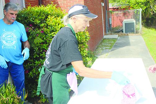 Bread of Life volunteer Susan Butler delivers food at First Presbyterian Church on Tuesday.