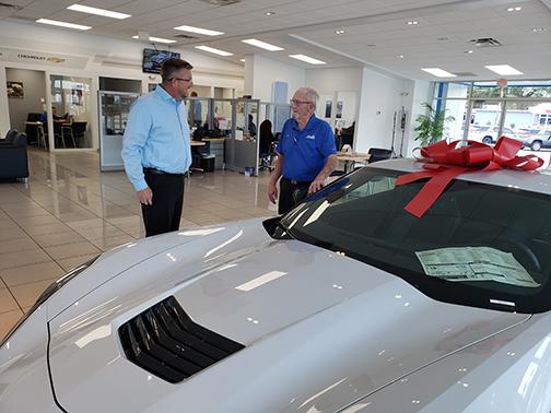 Sales consultant Bill Gaines, right, talks with Jeremy Alexander, general sales manager at Beck Chevrolet in Palatka. Now 81, Gaines has spent 50 years in the automotive industry.