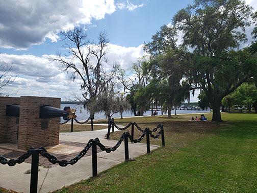 In the distance, a family enjoys a picnic under the shade along the riverfront in Palatka on a sunny day. Temperatures are expected to reach into the 90s this week in Putnam County.