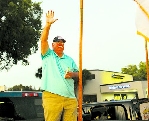 Pastor David Price stands on the back of his truck as he greets people arriving at the Putnam Community Medical Center parking lot. 