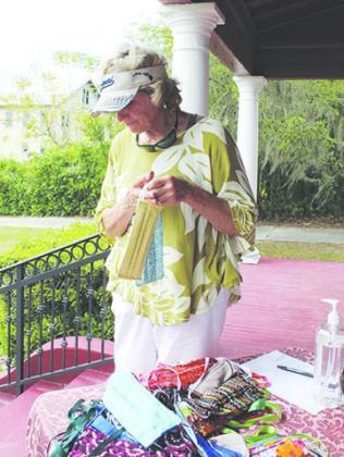 Palatka resident Linda Crider picks out hand-crafted masks Wednesday from the Palatka Art League.