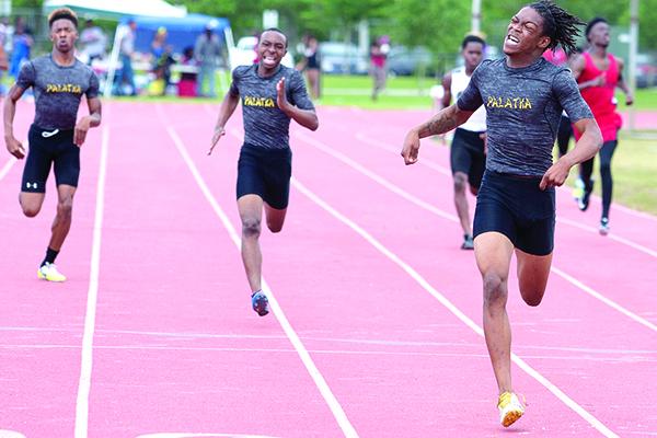 Robert Passmore easily wins the District 5-2A championship in the 400-meter dash on April 14, 2016, as teammates Lutrell Smith (middle) finishes second and Kendrick Aaron (left) takes third at Fred Cone Park, Gainesville. (Daily News file photo)