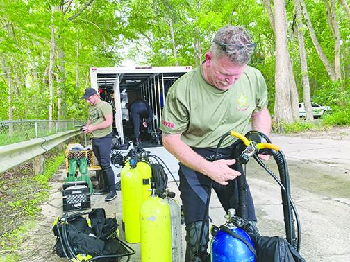 Putnam County Sheriff’s Office Lt. Steven Breckenridge, a member of the agency’s dive team, prepares to search for a missing boater Thursday evening.