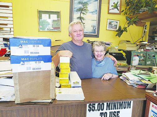 Sam Deputy and his mother, Jean Deputy, stand inside their Graphics II store on St. Johns Avenue in Palatka.