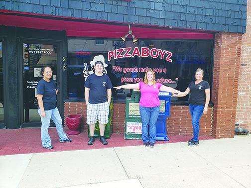 PizzaBoyz employees Michelle Cather, Michael Carson and Holly Sturdivant stand outside with owner Jeannie Ely.