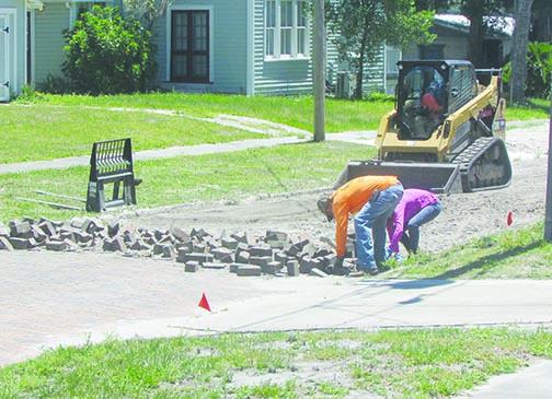Contruction workers collect bricks from Hotel Street in Palatka.