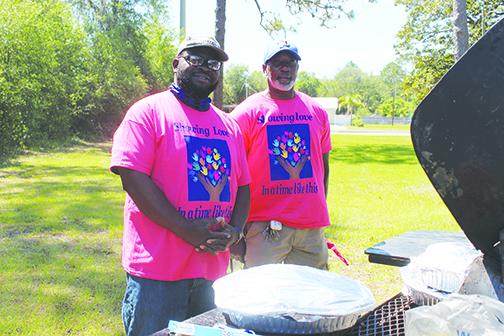 Pastor James Mathews and Steven Holmes cook ribs for Putnam Community Medical Center employees Friday. 