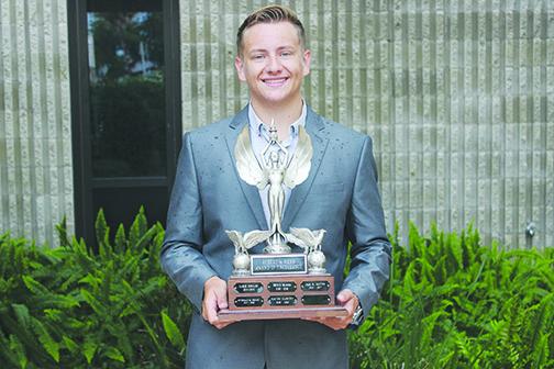 Palatka High School senior Colby Mikell shows the Robert W. Webb Award of Excellence Trophy that will be displayed at the school after he graduates.