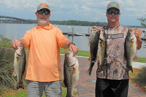Frank Streeter, left, and Brian Sousa hold up their winning catches on Saturday near the Palatka City Dock. (GREG WALKER / Special To The Daily News)