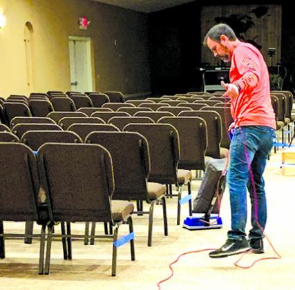 Pastor Dave Spedden of Living Hope in Florahome vacuums the church sanctuary. The church reopened for services last month while observing social distancing guidelines due to COVID-19.