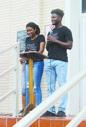 PEACE in the STREETS protest organizers Dar’Nesha Leonard and Tevel Adams speak to the crowd Thursday.