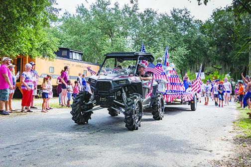 Parade participants make their way down the street during last year’s Independence Day Celebration in Interlachen.