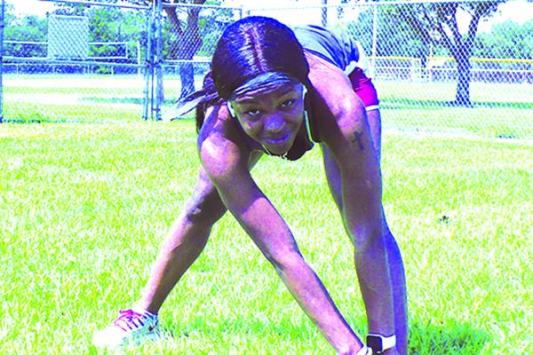 Florida State track star Ka’Tia Seymour stretches her muscles as she sets to work out last week. (MARK BLUMENTHAL / Palatka Daily News)