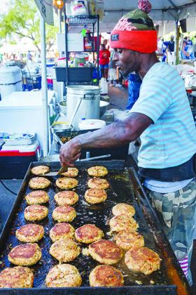 Victor Jones tries to keep up with the demand for what he boasted were the biggest and best crab cakes in all of Florida at the Blue Crab Festival last year.