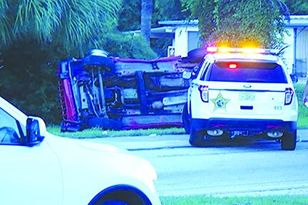 A red Jeep is flipped over on its side Monday after deputies used a maneuver to stop a man they said was driving erratically on U.S. 17.