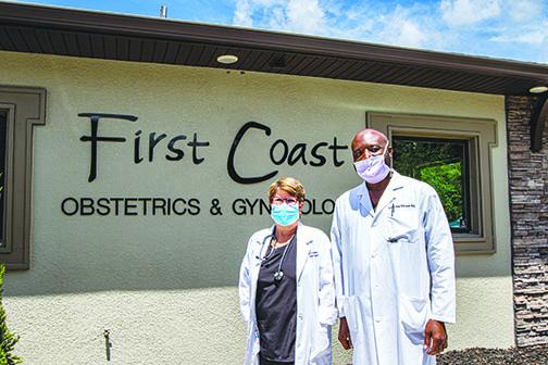 Dr. Lucien-Max Tchuisse and certified nurse midwife Alyn McGee take a break outside First Coast Obstetrics & Gynecology after seeing their patients Monday morning.