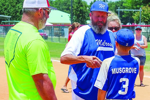 Melrose Babe Ruth U-12 team manager Dale Yarbrough congratulates one of last year’s standout players, Austin Musgrove, after his home run lifted Melrose to a 3-2 win over Lafayette. (MARK BLUMENTHAL / Palatka Daily News)